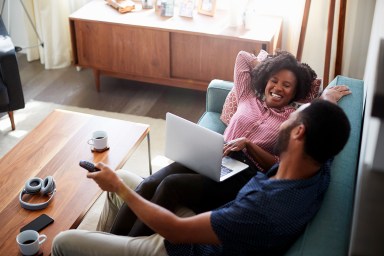 Couple on couch watching TV