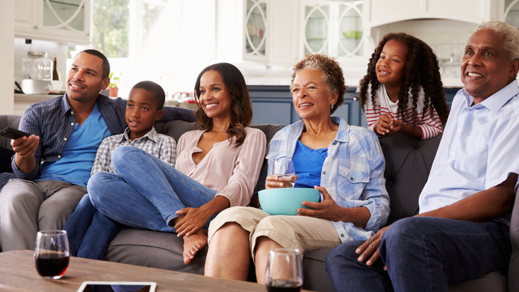 A Black family watches TV together