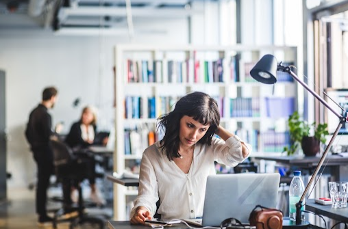 Women working with laptop and thinking as left hand on head 