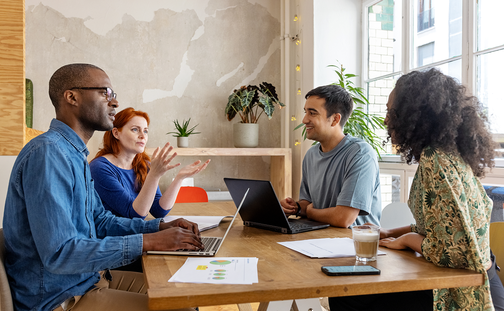 Advertisers reivewing customer analytics in a meeting using Nelsen's cross media planning solution.